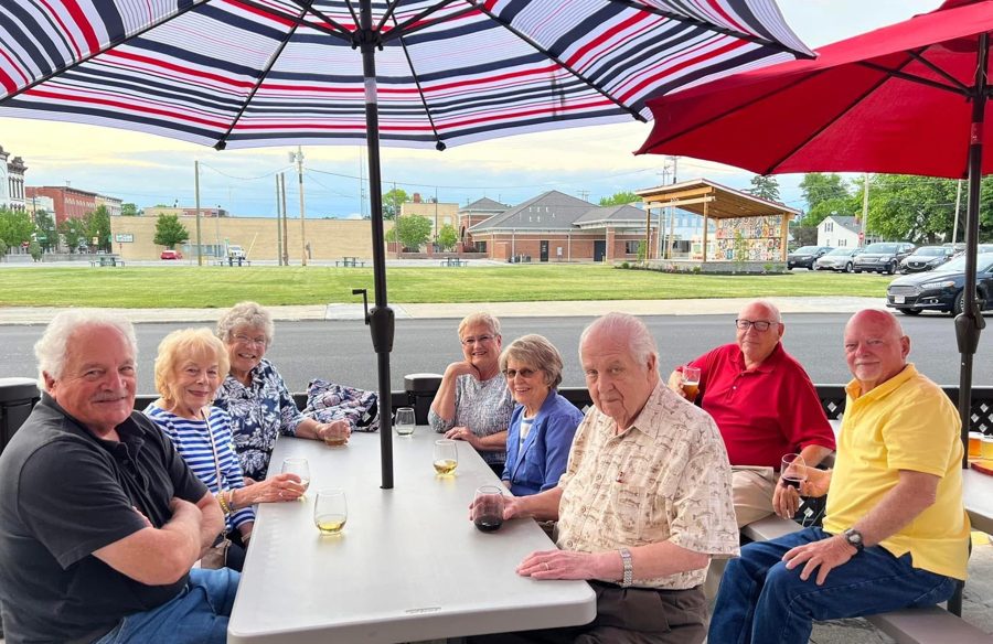 Picnic tables under umbrellas on the UrbanWoody outdoor patio